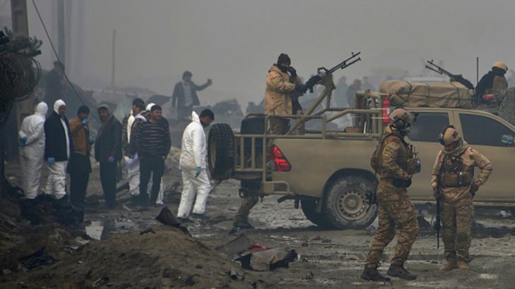 AFGHANISTAN-BRITAIN-UNREST-SECURITY EDITORS NOTE: Graphic content / Afghan security forces and investigators gather at the site of a suicide bomb attack outside a British security firm''s compound