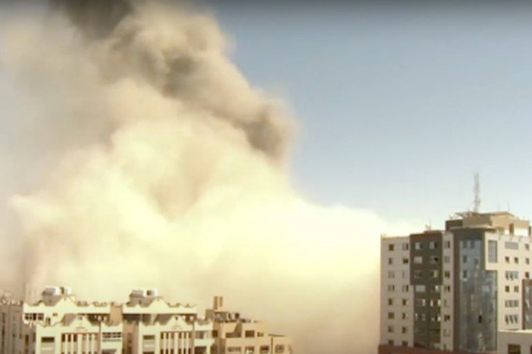 Smoke rises after a building housing residential apartments, as well as Al Jazeera and The Associated Press offices, collapsed following Israeli air raids