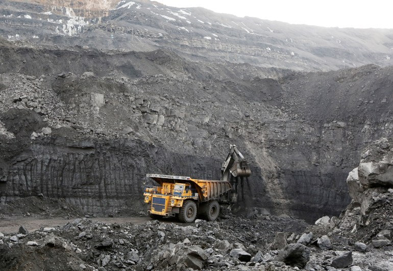 A machine loads a truck with coal at the Chernigovsky opencast colliery, outside the town of Beryozovsky, Kemerovo region, Siberia.