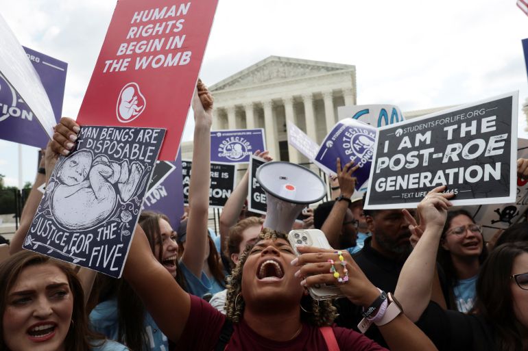 Anti-abortion demonstrators celebrate outside the Supreme Court