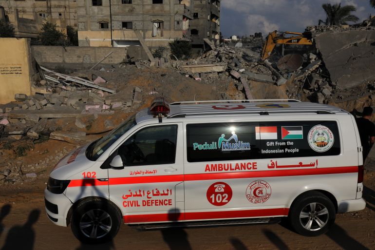 Civil defense teams and residents launch a search and rescue operation around the rubbles of destroyed buildings