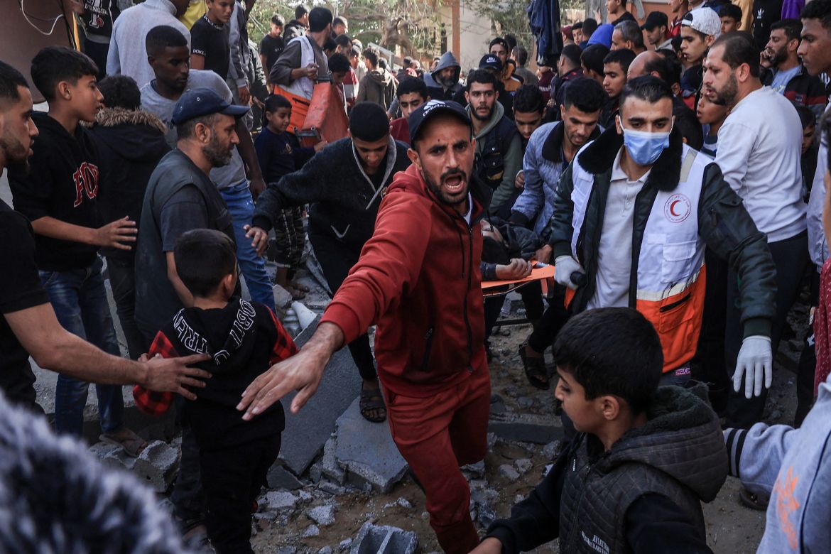 A Palestinian medic and civilians carry an injured man after an Israeli strike on Rafah, in the southern Gaza Strip.