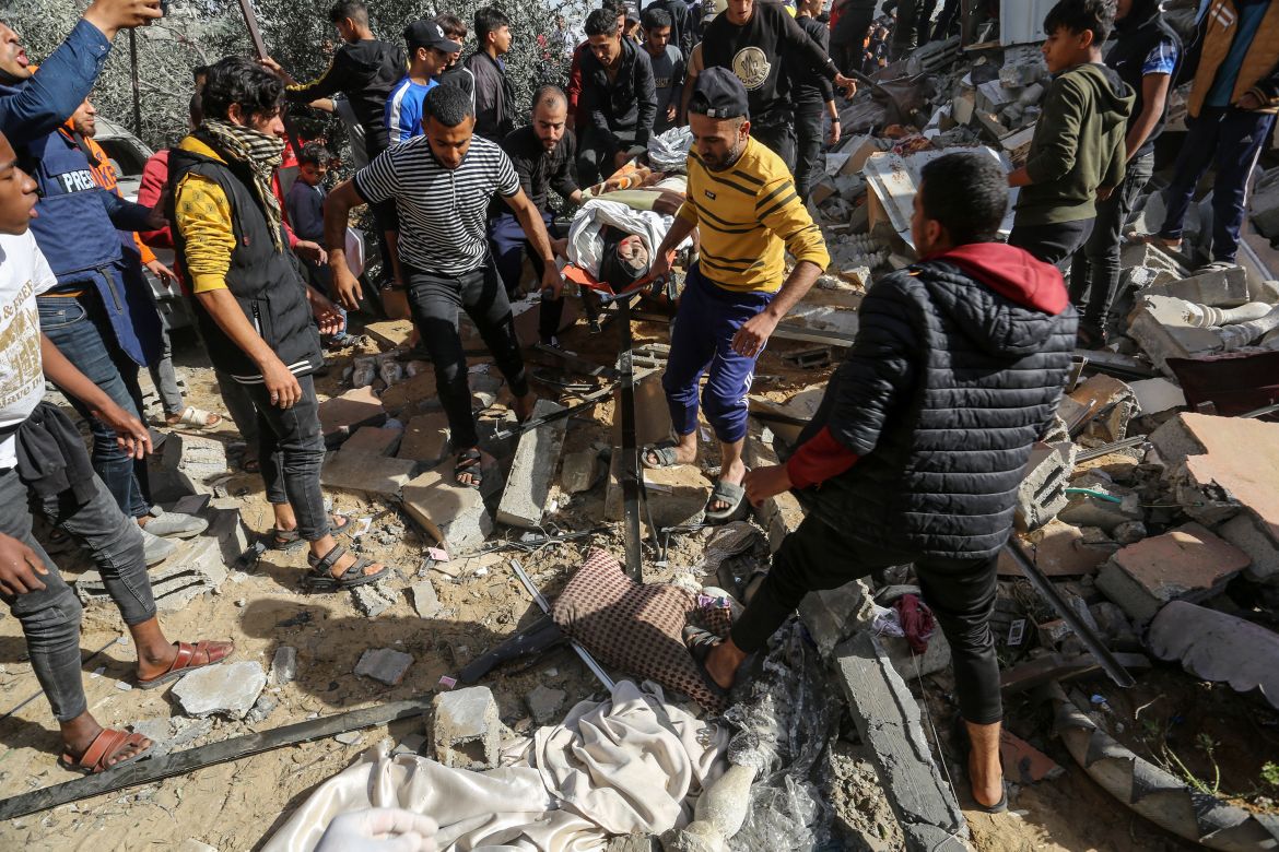 A Palestinian is saved under rubble as teams conduct search and rescue operations at debris of destroyed buildings after Israeli army's airstrikes while Israel's strikes continue on its 48th day in Rafah, Gaza.