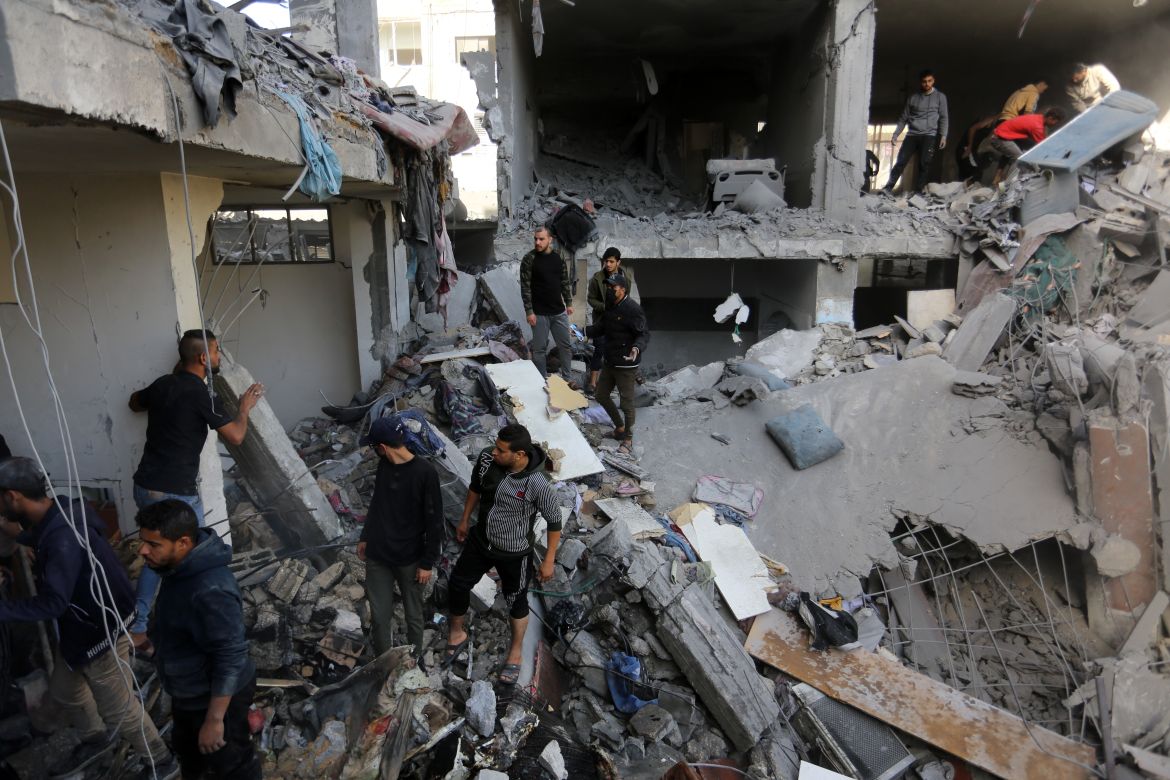 Residents and personnel conduct search and rescue works around the damaged site following Israeli attacks in Rafah, Gaza.
