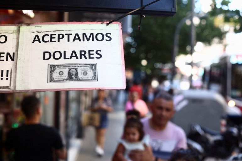 A sign outside a store reads in Spanish "We accept Dollars" in Buenos Aires, Argentina, December 12, 2023. REUTERS/Tomas Cuesta