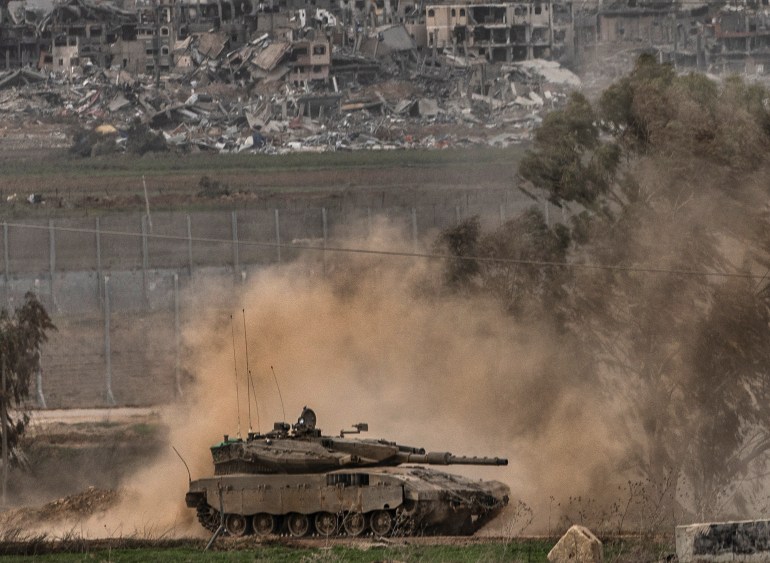 An Israeli army tank moves near the Gaza Strip border, in southern Israel, Saturday, Dec. 23