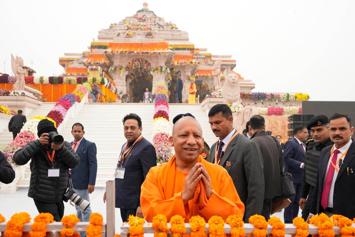 Uttar Pradesh Chief Minister Yogi Adityanath, center, greets people ahead of the inauguration of the temple of the Hindu god Ram in Ayodhya