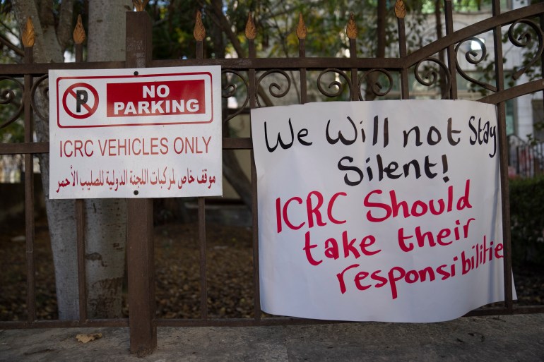 Placard saying "We will not stay silent! ICRC should take their responsibilities" on the ICRC fence