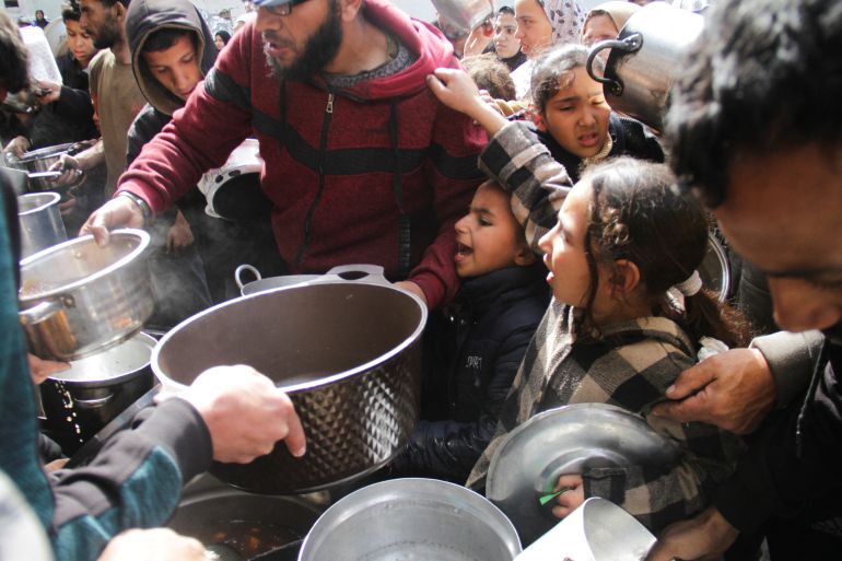 Palestinians gather to receive free food