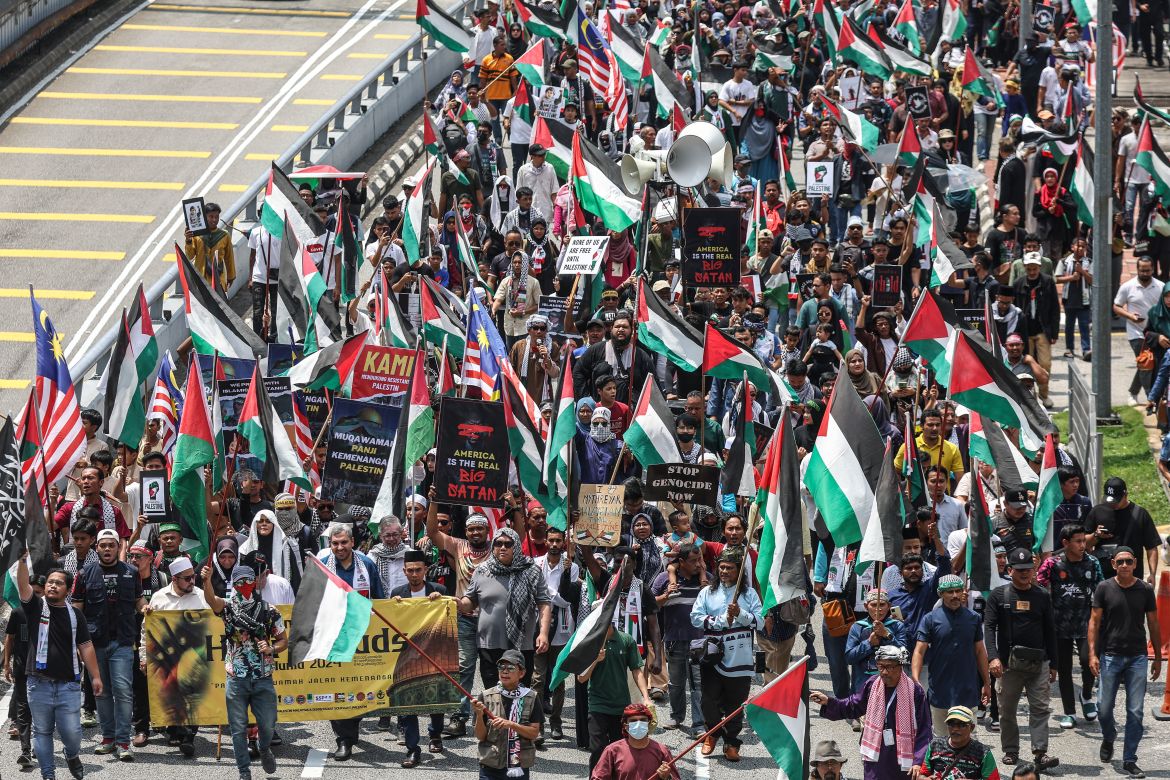 Protesters march towards the US embassy during the Al Quds Rally in solidarity with the Palestinian people, in Kuala Lumpur