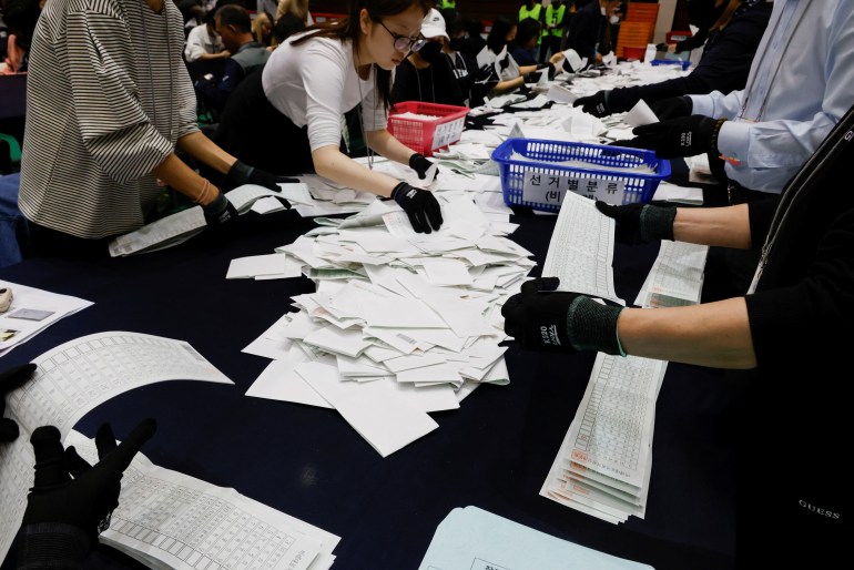 National Election Commission officials count ballots during the 22nd parliamentary election in Seoul, South Korea, April 10, 2024. REUTERS/Kim Soo-hyeon