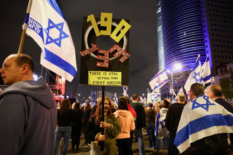 People hold banners as they attend a protest against Israeli Prime Minister Benjamin Netanyahu's government and to call for the release of hostages from Gaza, in Tel Aviv, Israel, April 13