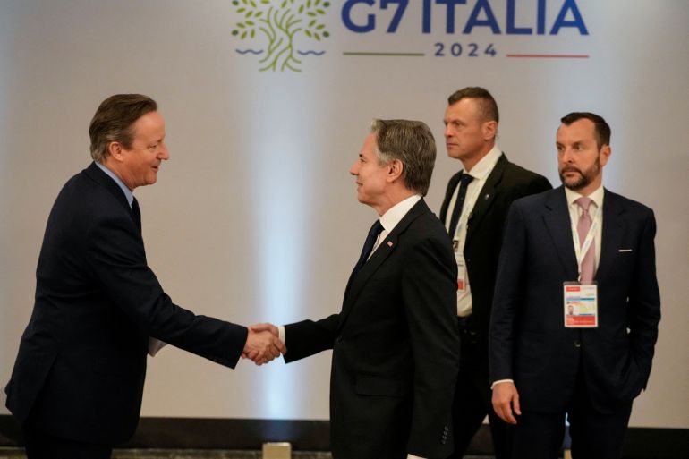 US Secretary of State Antony Blinken shakes hands with Britain's Foreign Secretary David Cameron,
