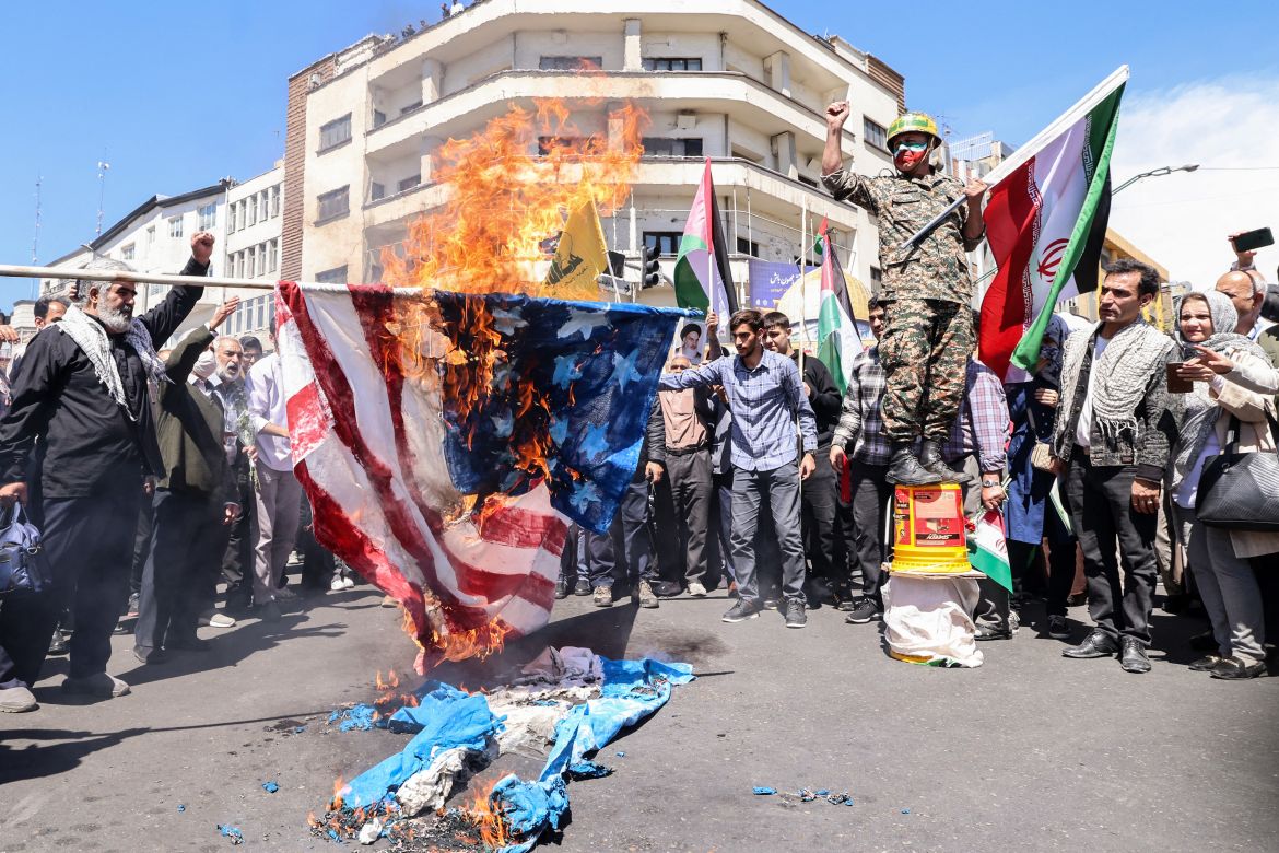 Iranians burn US and Israeli flags during the annual Quds (Jerusalem) Day commemorations and the funeral of seven Revolutionary Guard Corps members killed in a strike on the country's consular annex in Damascus