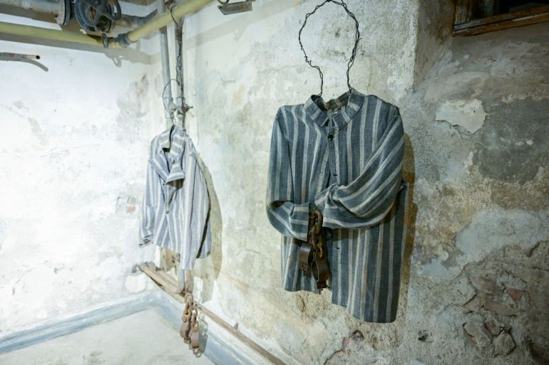 Inmates outfits are displayed in a cell at communist-era Pitesti prison in Jilava