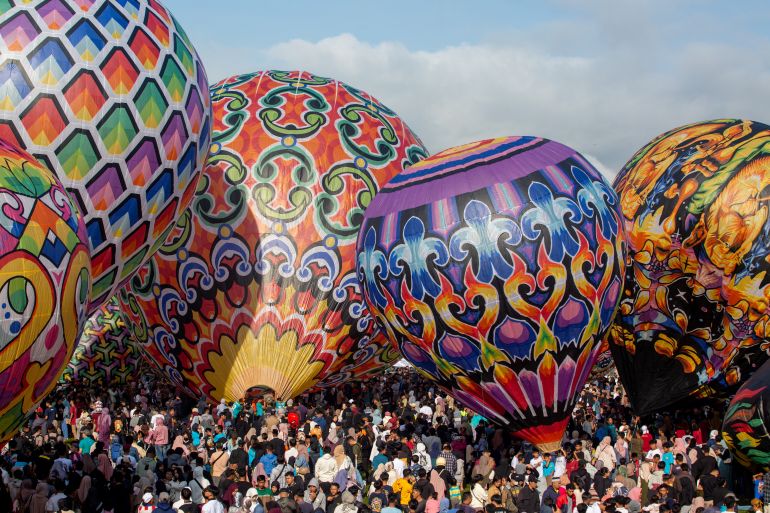 Participants prepare to fly hot air balloons during the traditional hot air balloon festival, an annual event since 1950, during the Eid al-Fitr holiday celebrating the end of the Muslim holy fasting month of Ramadan, in Wonosobo, Central Java on April 11