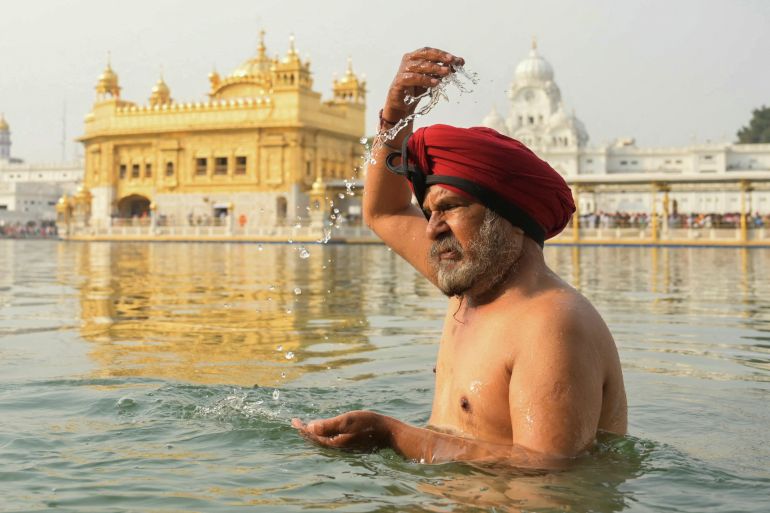 A Sikh devotee bathes in the holy sarovar (water tank) on the occasion of 'Baisakhi' a spring harvest festival, at the Golden Temple in Amritsar on April 13
