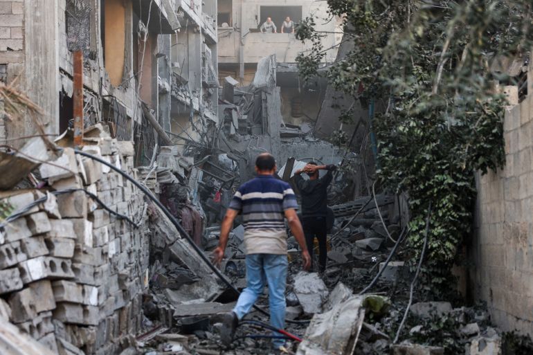 Palestinians check the rubble of a building after Israeli bombardment at Al-Daraj neighbourhood