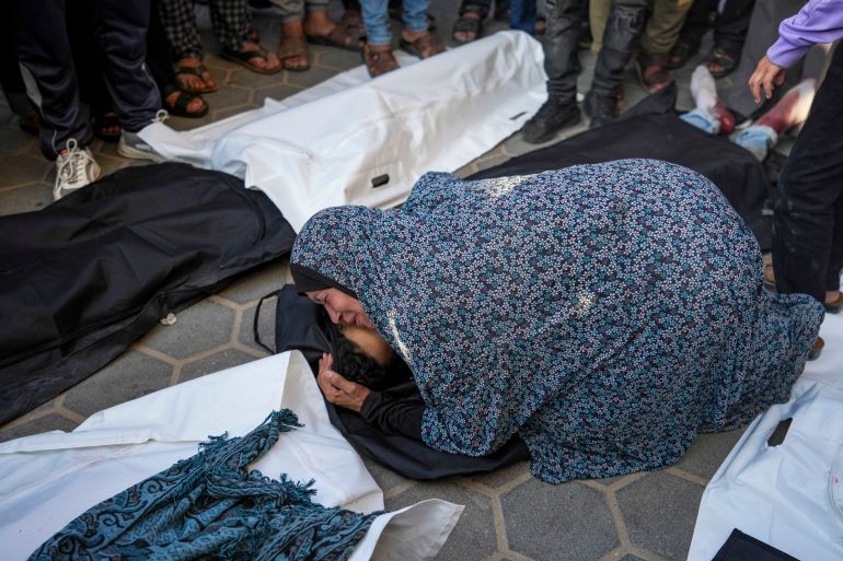 A woman mourns over her dead son in the Al Aqsa hospital in Deir al Balah following an Israeli bombardment in the Maghazi refugee camp, central Gaza Strip, Tuesday, April 16, 2024. Several killed in a strike in Maghazi camp in Central Gaza on Tuesday. (AP Photo/Abdel Kareem Hana)