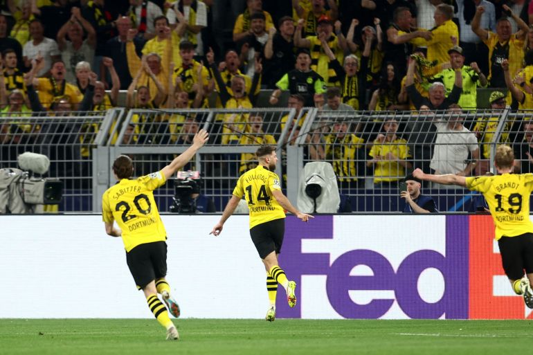 Borussia Dortmund's Niclas Fullkrug celebrates scoring their first goal with Marcel Sabitzer and Julian Brandt