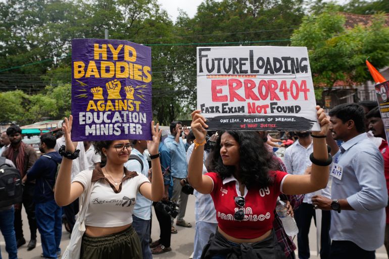Supporters of the Cockroach Janta Party hold placards during a protest.