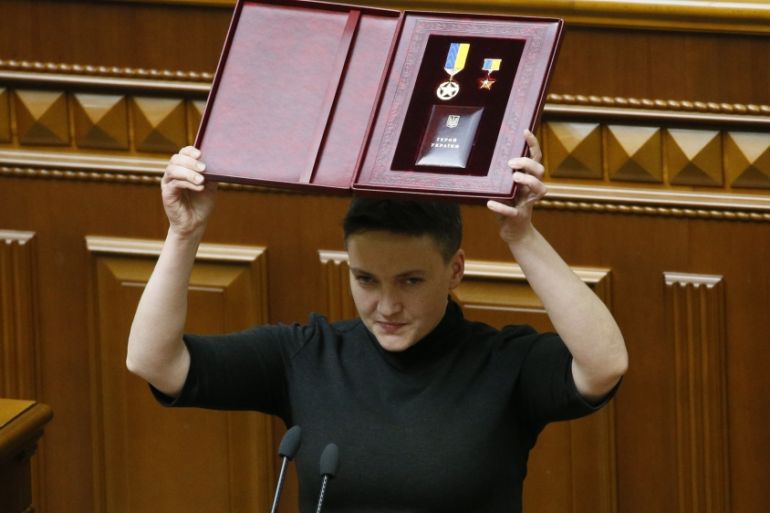 Ukrainian parliamentary deputy Nadiya Savchenko shows her Star of the Hero of Ukraine during a parliament session in Kiev