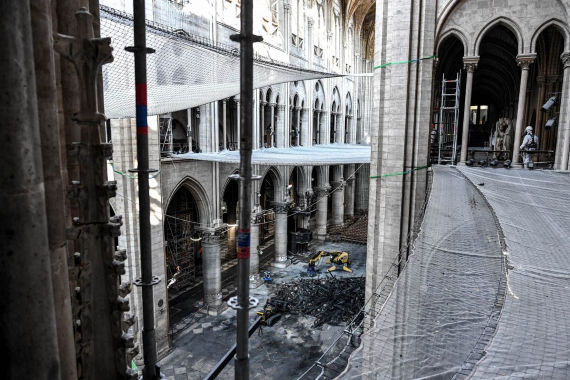 A picture shows damage on the nave and rubble during preliminary work in the Notre-Dame de Paris Cathedral three months after a major fire on July 17, 2019 in Paris. French MPs on July 16 approved a l