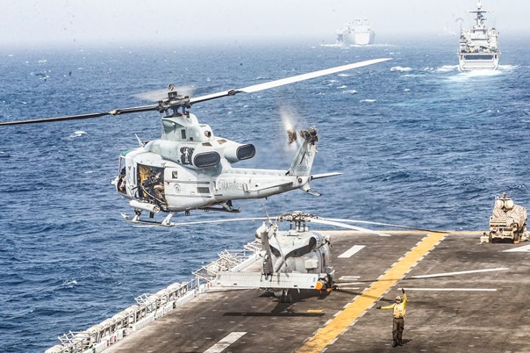 .S. Marines UH-1Y Venom helicopter takes off from the flight deck of the U.S. Navy amphibious assault ship USS Boxer, near a Light Marine Air Defense Integrated System (LMADIS) counter-unmanned aircra
