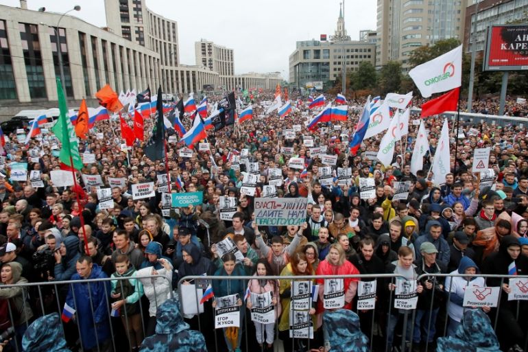 People attend a rally to demand authorities allow opposition candidates to run in a local election in Moscow