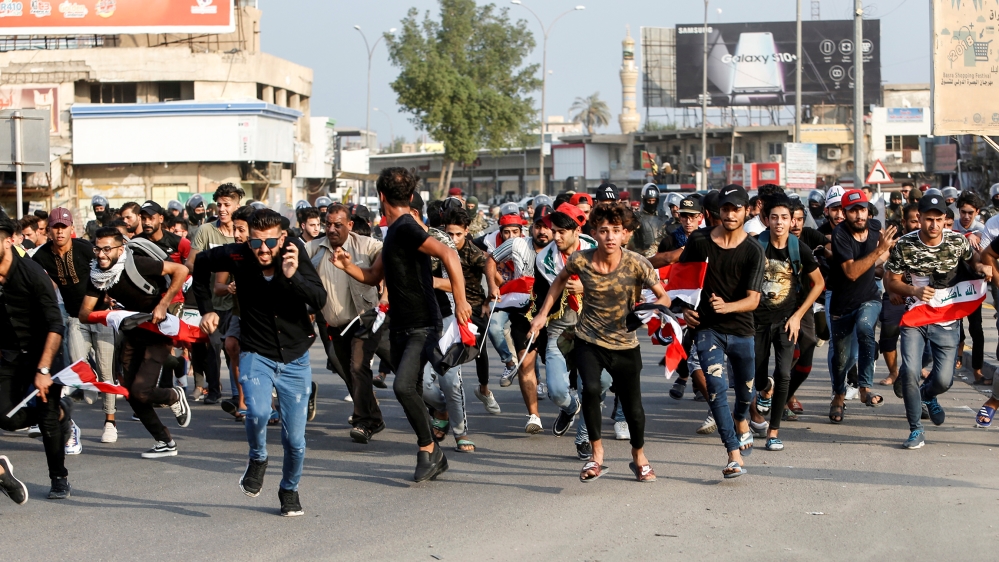 Demonstrators run as they take part in a protest over unemployment, corruption and poor public services, in Basra, Iraq October 2, 2019. REUTERS/Essam al-Sudani