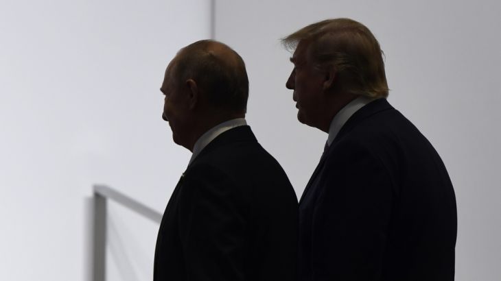 FILE - In this June 28, 2019, file photo, President Donald Trump and Russian President Vladimir Putin walk to participate in a group photo at the G20 summit in Osaka, Japan.