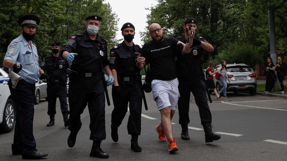 Policemen detain a participant of a picket in support of former journalist Ivan Safronov in Moscow