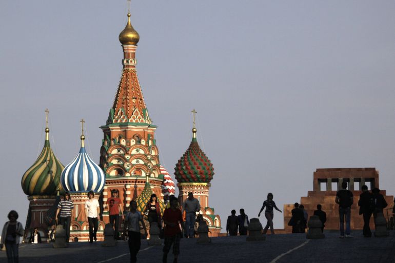 Pedestrians walk past St. Basil's Cathedral in Red Square in Moscow, Russia