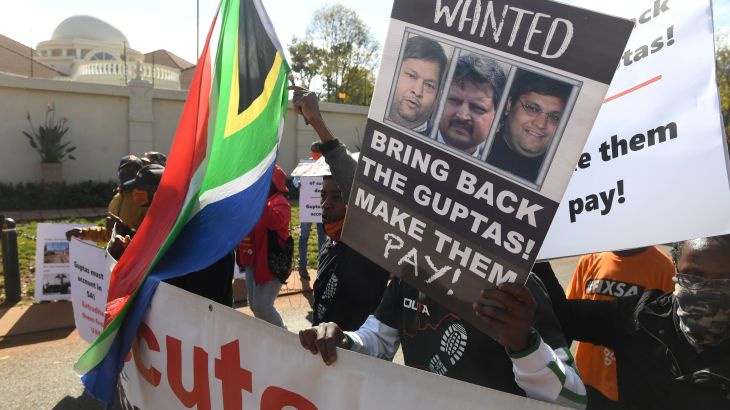 A group of people protest outside the United Arab Emirates' (UAE) embassy calling for the speedy extradition of the Guptas on June 10, 2021 in Pretoria, South Africa. It is reported that Gupta brothers Atul and Rajesh, and their wives Chetali and Arti and 17 others were accused on a charge of money laundering of R24.9 million.
