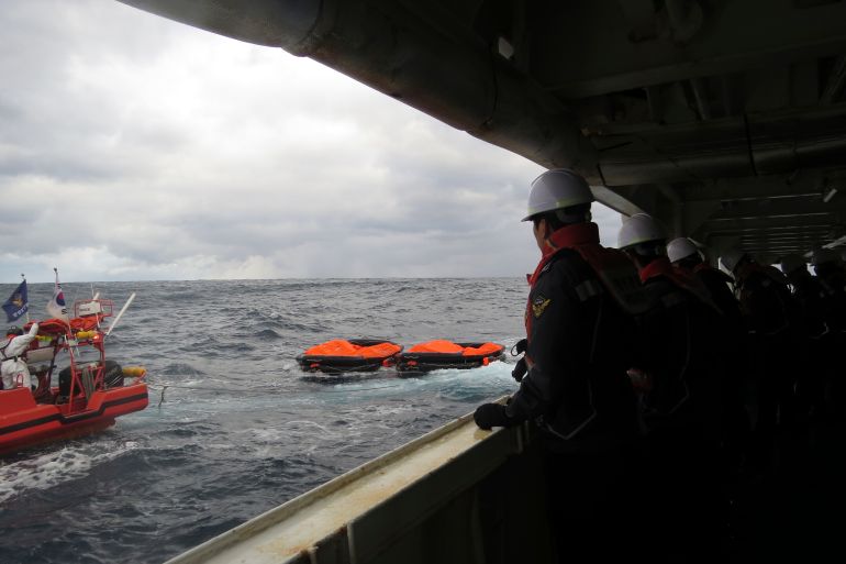 In this photo provided by the Korea Coast Guard, members of the South Korea coast guard conduct a search operation in waters between South Korea and Japan.