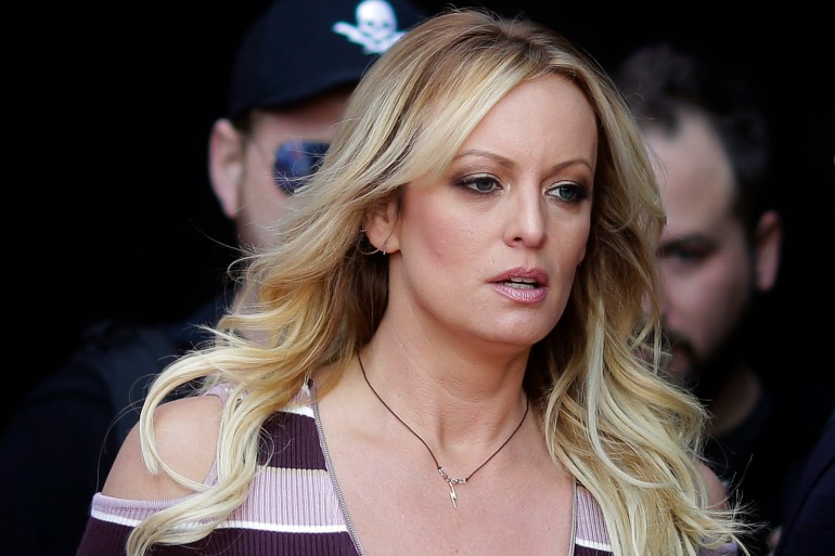 Stormy Daniels seen walking, with law enforcement behind her
