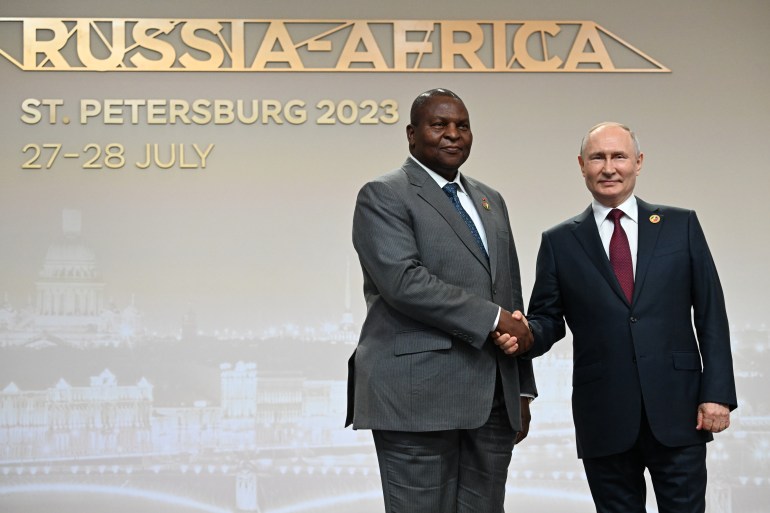 This pool image distributed by Sputnik agency shows Russian President Vladimir Putin greeting Central African Republic President Faustin-Archange Touadera during a welcoming ceremony at the second Russia-Africa summit in Saint Petersburg on July 27, 2023. (Photo by Pavel BEDNYAKOV / POOL / AFP)