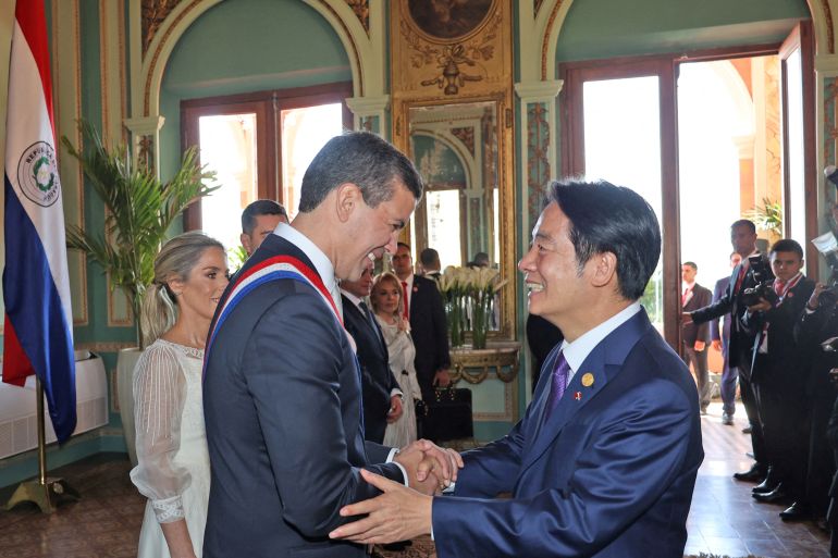 Paraguay's new President Santiago Pena shakes hands with Taiwan's Vice President William Lai shaking hands at Pena's inauguration. The two men look friendly and relaxed.