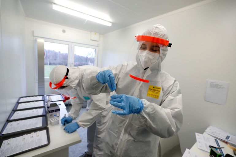 Medical workers examine the rapid antigen tests