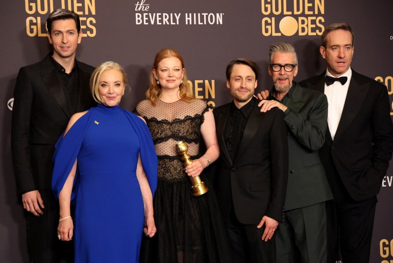 The cast of Succession including Sarah Snook Mathew Macfadyen and Kieran Culkin Snook is holding the Golden Globe