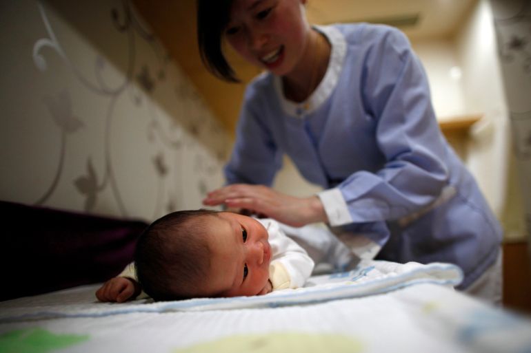 An employee massages a baby at the CareBay maternity care centre in Shanghai December 16, 2011. CareBay is a high-end maternity care centre in providing private services for "Zuo Yue Zi," or confinement period in Mandarin, a Chinese practice for mothers who have just given birth to stay indoors, undergo a restrictive diet and set of activities for a month. Traditionally, mother-in-laws are the ones overseeing the confinement period, but today, the task is left to a nurse or the mother herself. The centre has about 120 employees including maternity care experts, health consultants, beauticians and nutritionists who would look after the new mothers as well as their babies. The cost for a one-month service is between 79,800 yuan ($12,600) and 380,000 yuan ($60,000), covering food, accommodation, slimming exercises and yoga lessons for the mother and nursing services for the child. Picture taken December 16, 2011. REUTERS/Aly Song (CHINA - Tags: SOCIETY HEALTH BUSINESS)