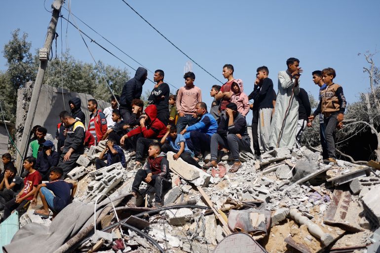 Palestinians gather at the site of an Israeli airstrike on a building,