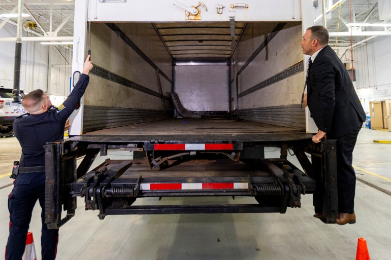 Police officers open the back of the truck used in the 'largest gold theft' in Canadian history