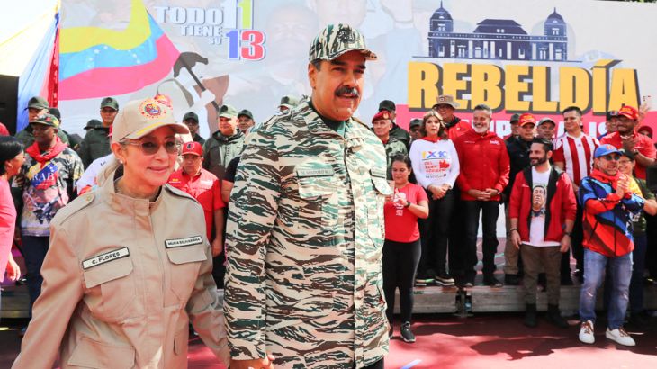 Venezuelan President Nicolas Maduro (C) and First Lady Cilia Flores arrive at a political rally in Caracas, on April 13