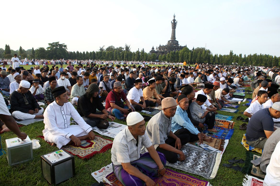 Muslims perform Eid al-Fitr prayers marking the end of the holy fasting month of Ramadan at a field in Denpasar, Bali,