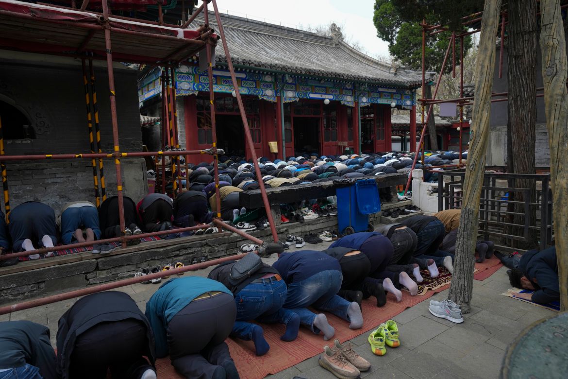 Muslim men offer the Eid al-Fitr prayers to mark the end of the holy fasting month of Ramadan at the Niujie Mosque in Beijing,