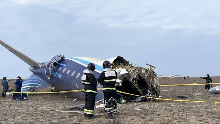 Kazakh emergency specialists work at the crash site of the Azerbaijan Airlines passenger jet near the western Kazakh city of Aktau