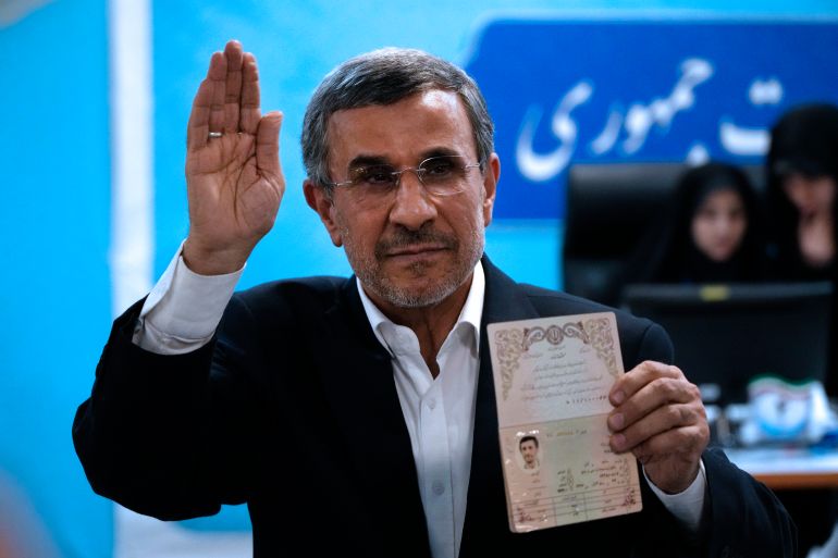 Iran's former President Mahmoud Ahmadinejad shows his identification document.