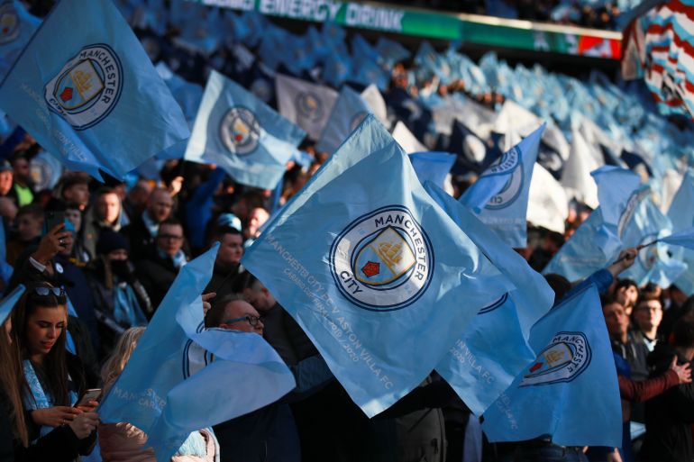 Manchester City fans wave the team's flag