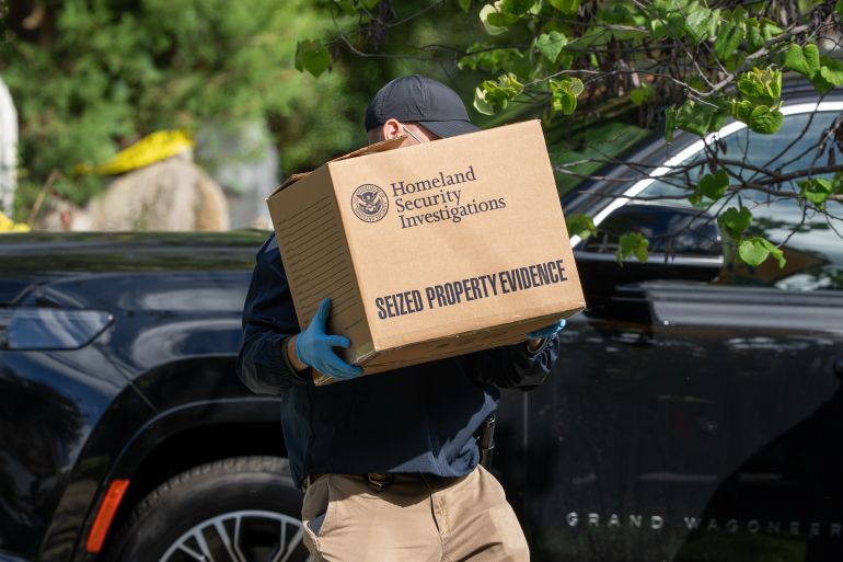 Homeland Security officers carry boxes from the Washington residence of Rep. Ilhan Omar, D-Minn., Monday, Oct. 12, 2026, during a search. (AP Photo/J. Scott Applewhite)